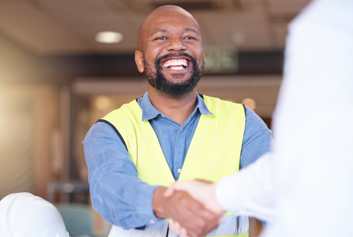 builder smiling and shaking hands with a customer